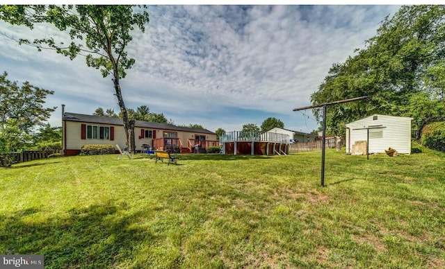 view of yard with a storage shed and a deck