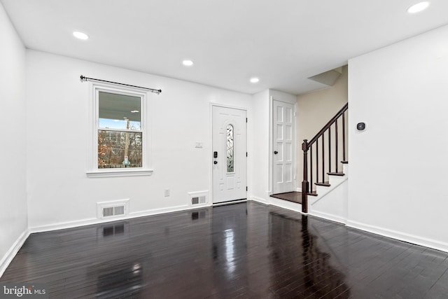 foyer entrance featuring dark hardwood / wood-style floors