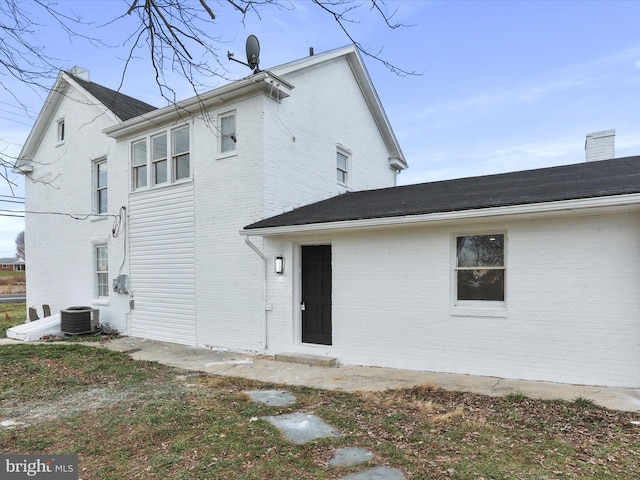 rear view of property with central AC unit