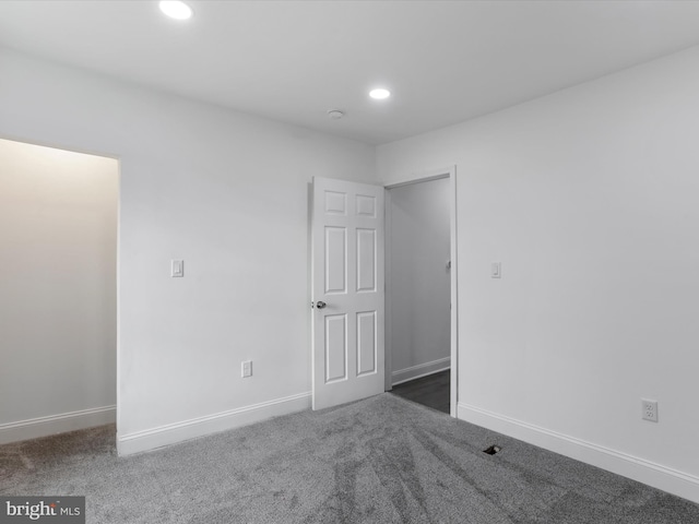 empty room with dark carpet