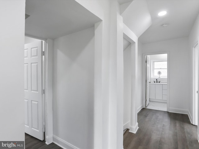 hall with dark hardwood / wood-style flooring and sink