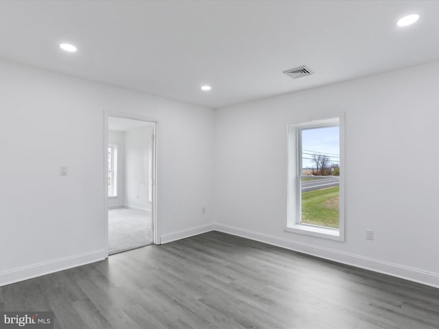 unfurnished room with dark wood-type flooring