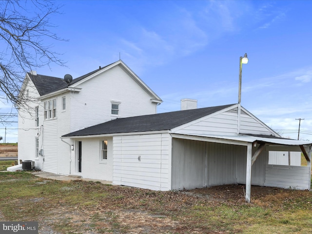 back of house featuring central air condition unit