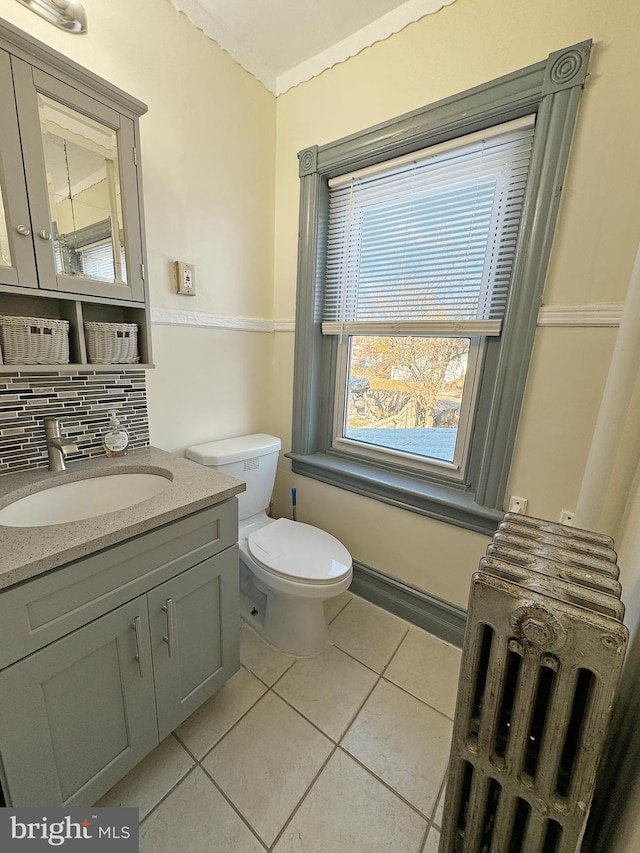 bathroom featuring tile patterned flooring, vanity, tasteful backsplash, and toilet