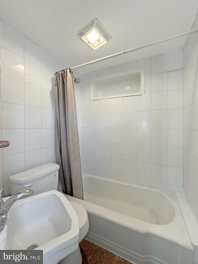 full bathroom featuring tile walls, toilet, shower / bathtub combination with curtain, and sink