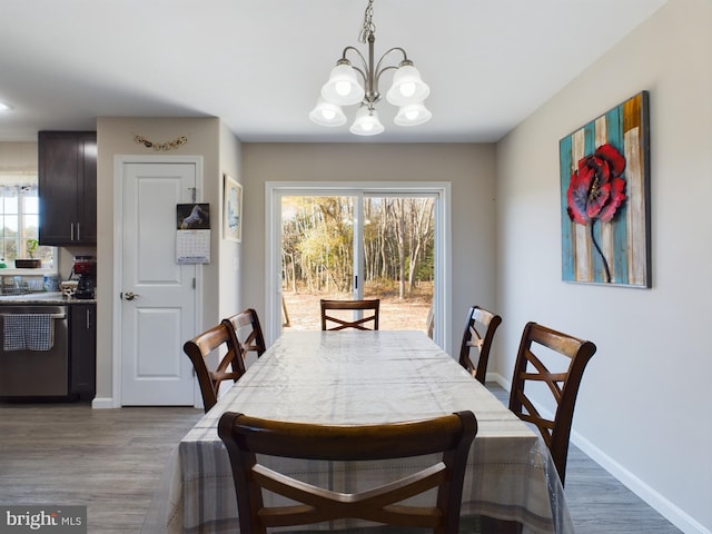 dining room featuring light hardwood / wood-style flooring and an inviting chandelier