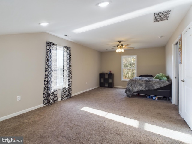 carpeted bedroom with ceiling fan and lofted ceiling