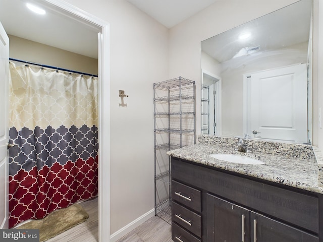 bathroom featuring hardwood / wood-style flooring and vanity