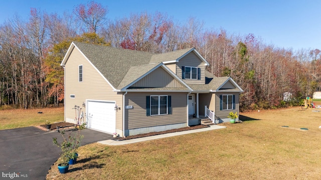 view of front of home featuring a front yard and a garage