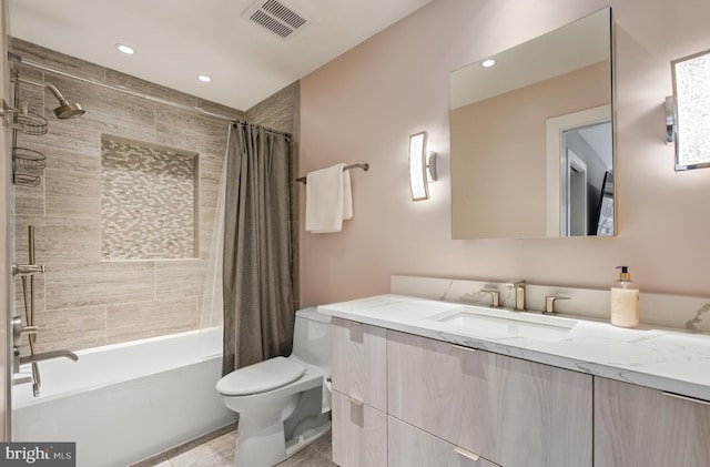 full bathroom featuring vanity, shower / tub combo, and toilet