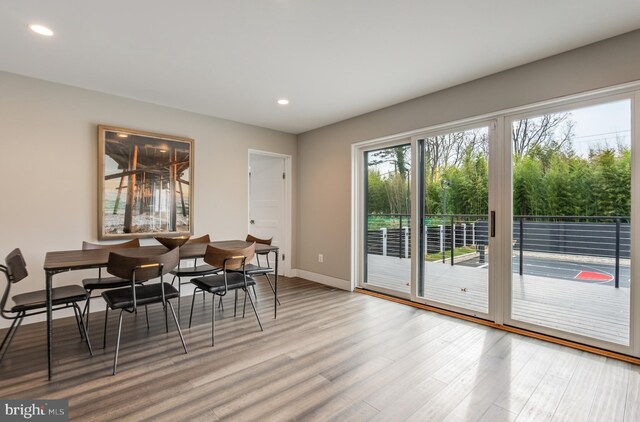 dining space with wood-type flooring