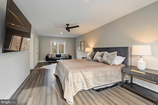 bedroom with hardwood / wood-style floors and ceiling fan