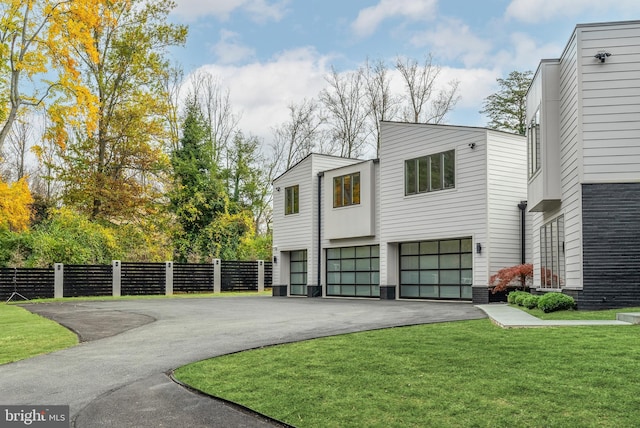 view of front of house featuring a front yard and a garage