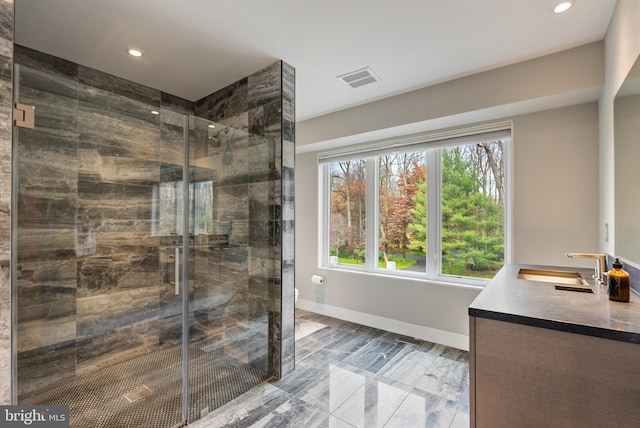 bathroom featuring vanity and a shower with shower door