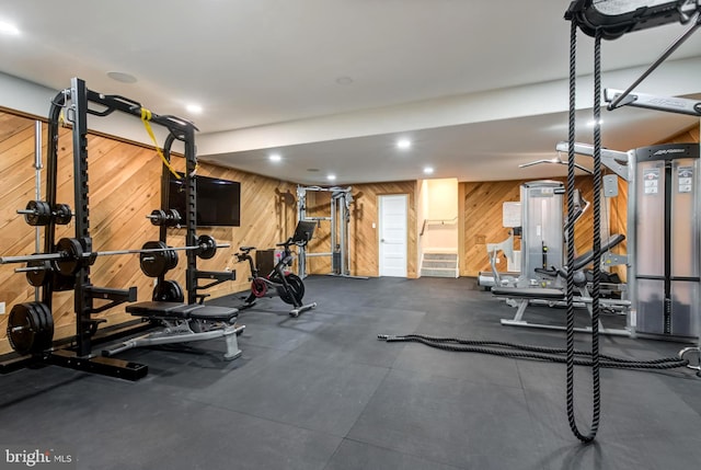 workout room featuring wood walls