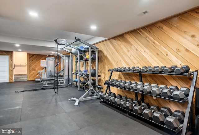 workout area featuring wood walls