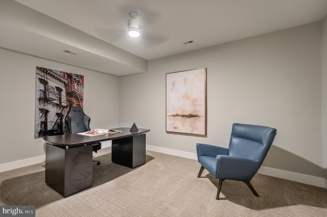 carpeted office featuring ceiling fan