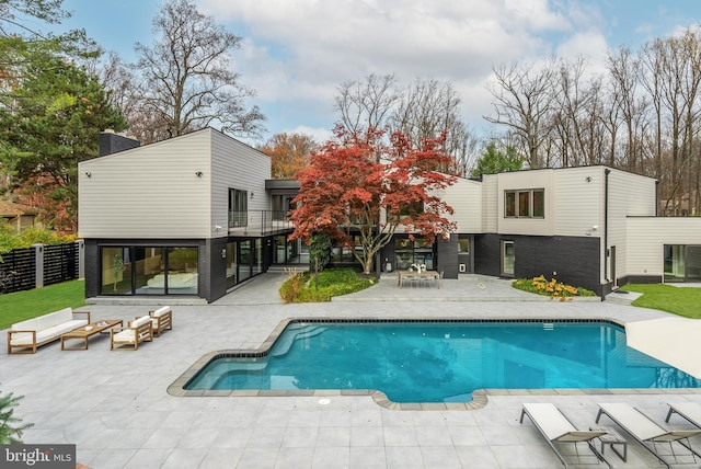 back of house with a patio and a balcony