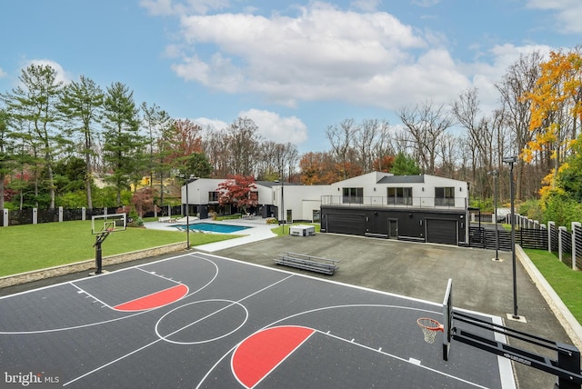 view of sport court with a fenced in pool and a lawn