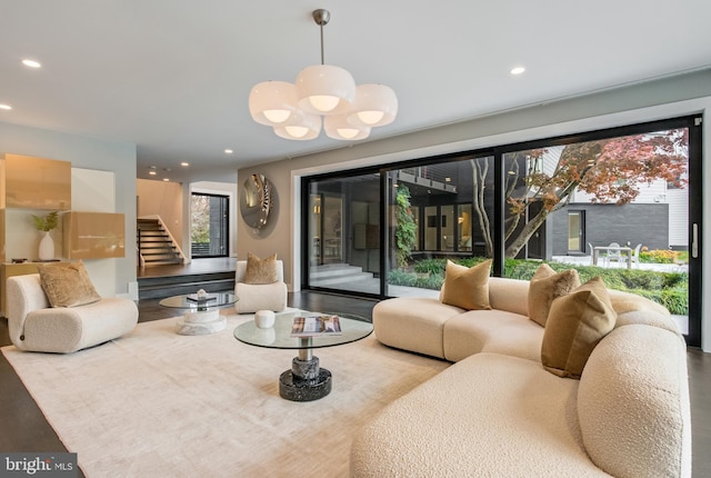 living room with hardwood / wood-style floors and an inviting chandelier