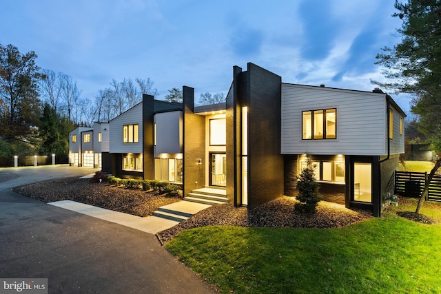 modern home featuring a lawn