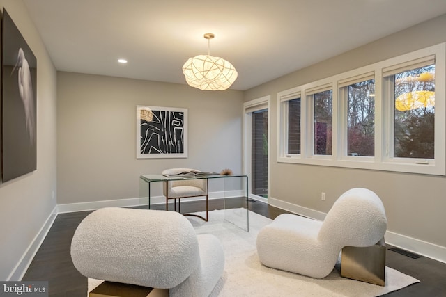 sitting room featuring dark wood-type flooring