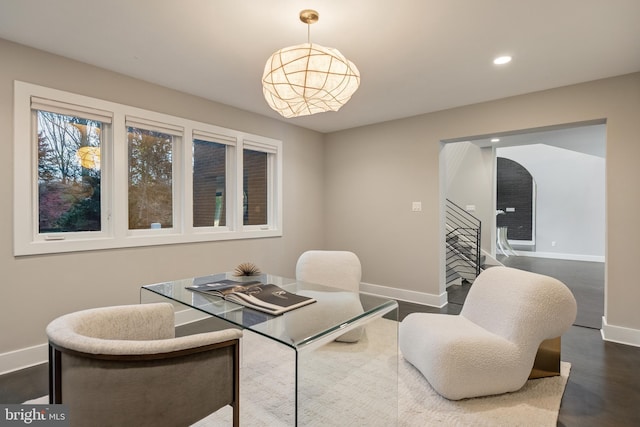 dining room featuring an inviting chandelier and dark wood-type flooring