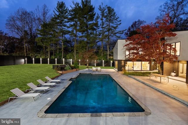 view of swimming pool with a yard and a patio