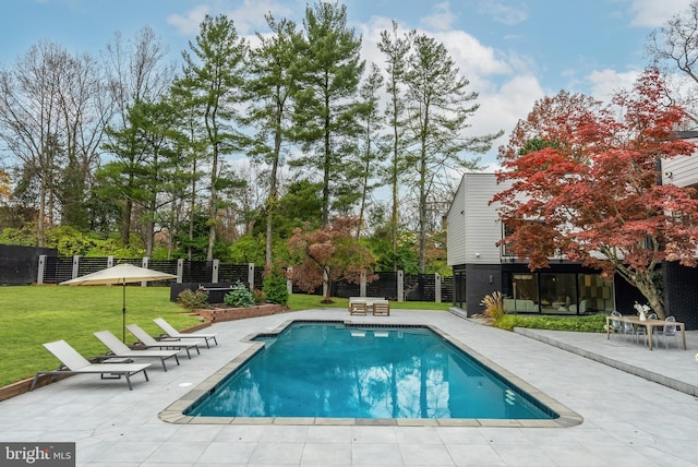 view of swimming pool with a lawn and a patio