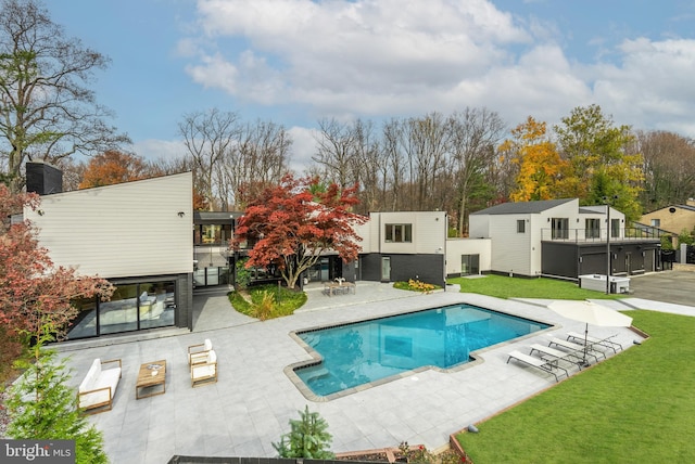 view of swimming pool with a patio area and a hot tub