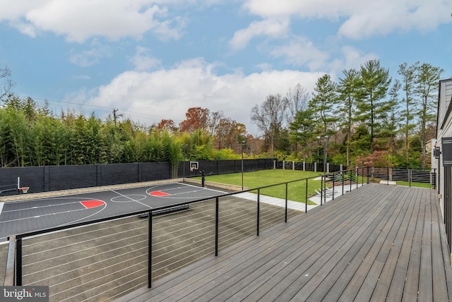 deck with a lawn and basketball hoop