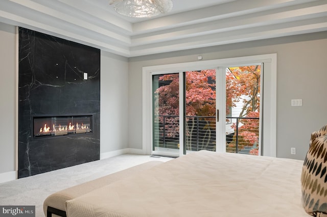 carpeted bedroom featuring access to exterior and a fireplace