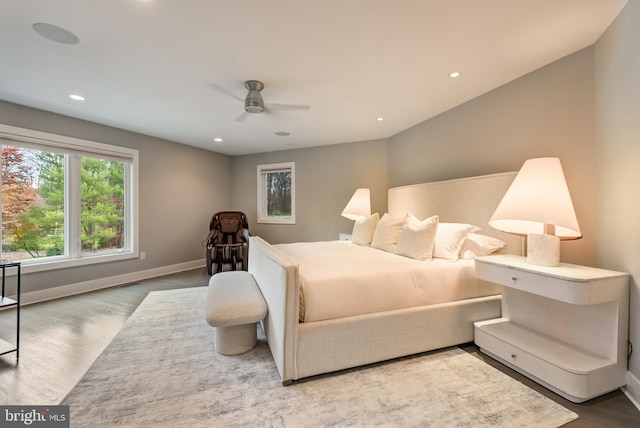 bedroom with hardwood / wood-style flooring, ceiling fan, and lofted ceiling