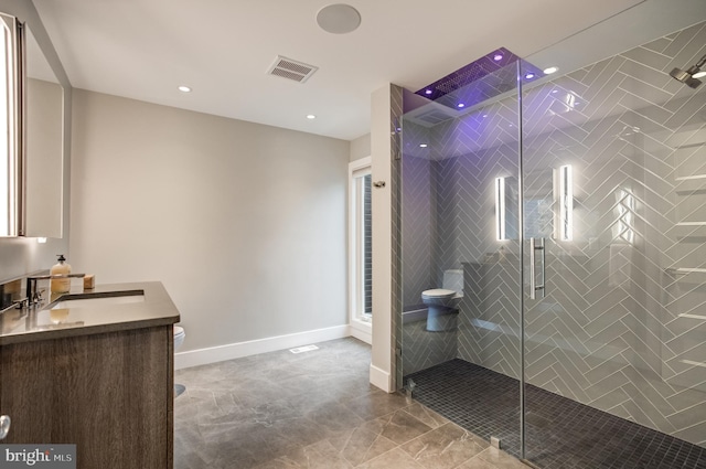 bathroom featuring vanity, an enclosed shower, and toilet