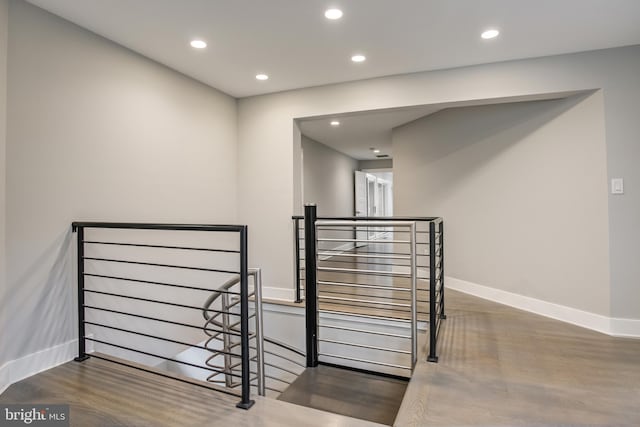 stairway with hardwood / wood-style floors