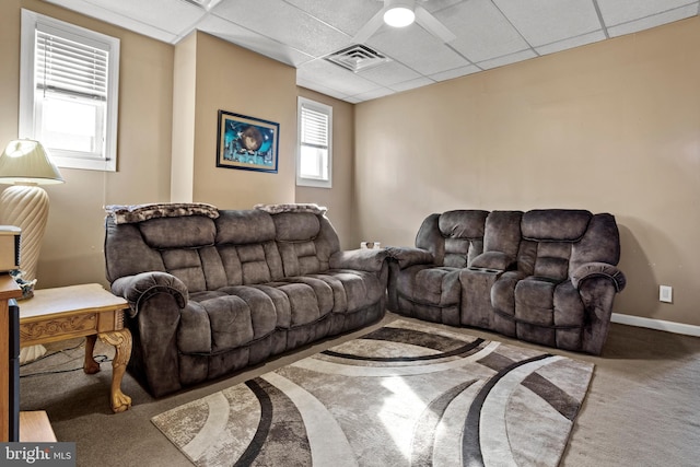 carpeted living room featuring a paneled ceiling