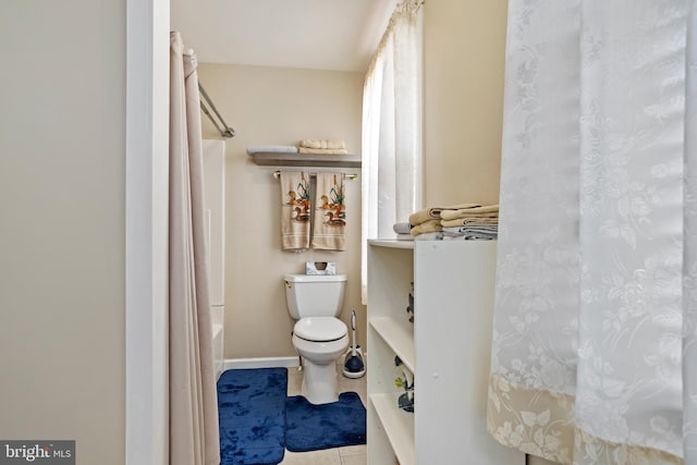 bathroom with tile patterned floors, toilet, and shower / bath combo