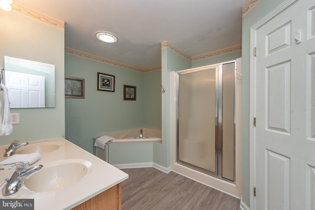 bathroom featuring hardwood / wood-style floors, vanity, and plus walk in shower