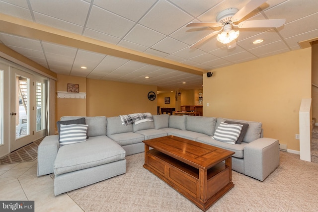 tiled living room with french doors, a paneled ceiling, and ceiling fan