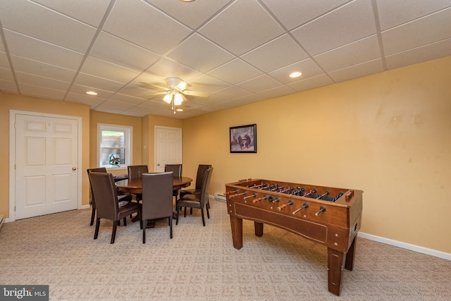 game room featuring a paneled ceiling, ceiling fan, and light colored carpet