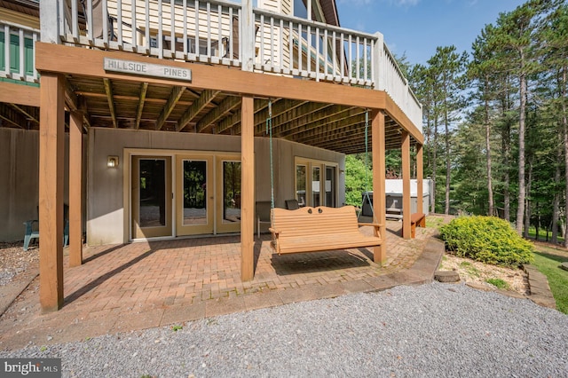 exterior space featuring a hot tub and a deck