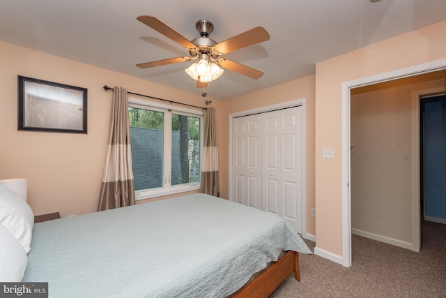 carpeted bedroom with ceiling fan and a closet