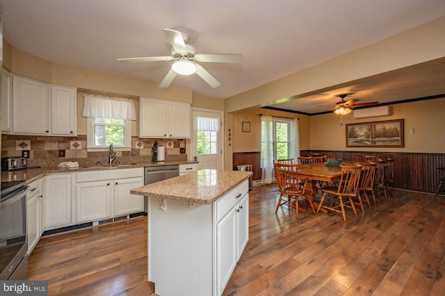 kitchen featuring a wealth of natural light, white cabinets, and dark wood-type flooring