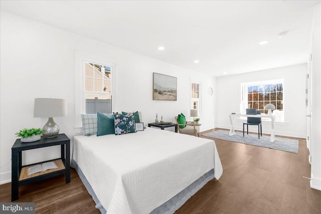 bedroom with dark hardwood / wood-style flooring