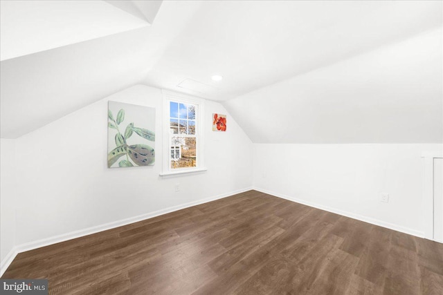 additional living space featuring dark hardwood / wood-style flooring and lofted ceiling