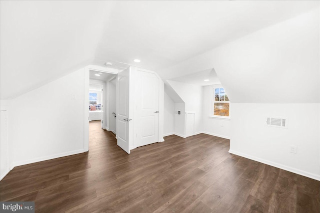 additional living space with lofted ceiling and dark wood-type flooring