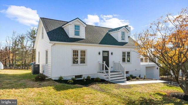 cape cod house featuring a garage, a front yard, and central AC