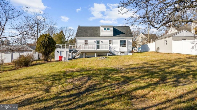 back of house with a lawn and a deck