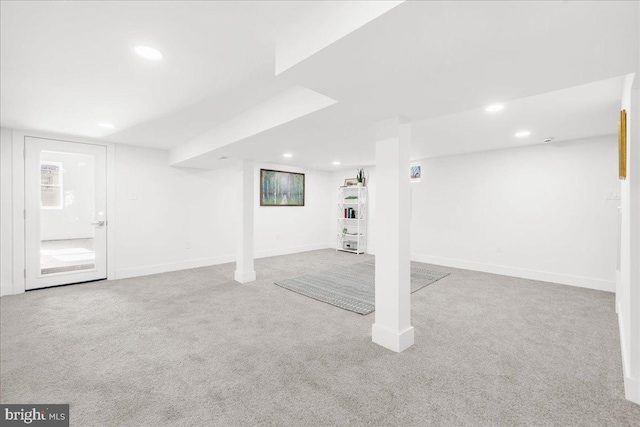 basement featuring light colored carpet