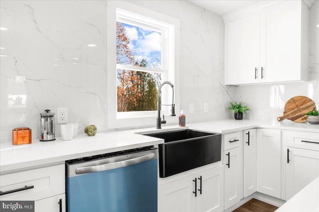 kitchen featuring dark hardwood / wood-style flooring, white cabinetry, stainless steel dishwasher, and sink